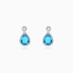 Halo sterling silver drop earrings with blue topaz
