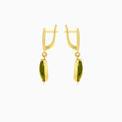 Oval cut modavite in gold earrings