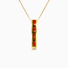 Long channel set garnet gold pendant