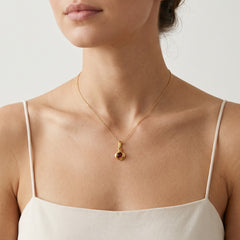 Stylish garnet pendant in tension setting