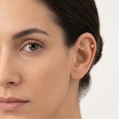Gold compas ear piercing