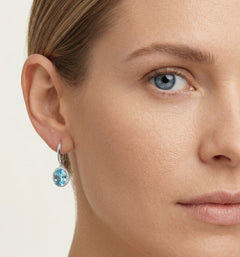 Halo sterling silver dangling earrings with blue topaz