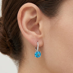Sterling silver drop earrings with round blue topaz
