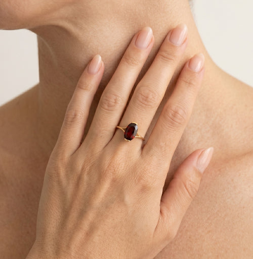 Garnet oval cut gold ring on bar set