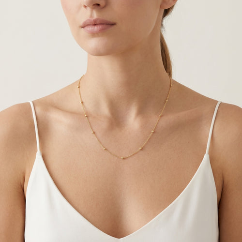 Elegant gold necklace with little balls