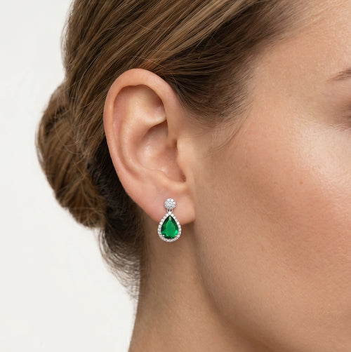Halo sterling silver drop earrings with emerald