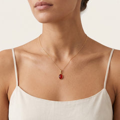 Oval cut garnet pendant in bezel setting
