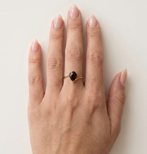 Graceful pear cut garnet in 14kt gold