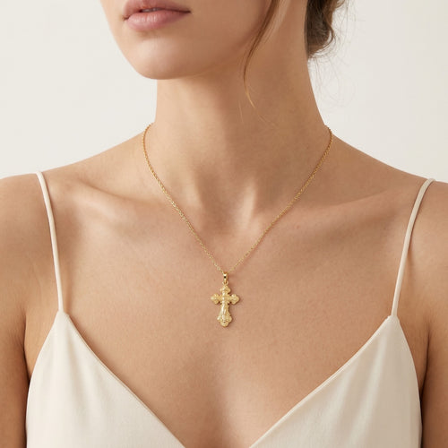 Kleines goldenes Kreuz mit detaillierter Jesus-Darstellung