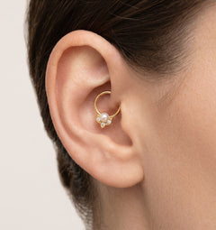 Elegant gold hoop piercing with cubic zirconia and pearl