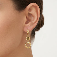 Gold dangling earrings with a circle and a coin