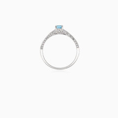 Elegant white gold ring with diamond and blue topaz