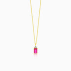A beautiful gold necklace with a synthetic ruby pendant