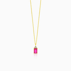 A beautiful gold necklace with a synthetic ruby pendant