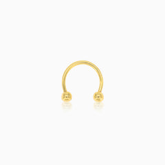 Two gold balls gold piercing