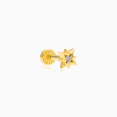 Gold compas ear piercing