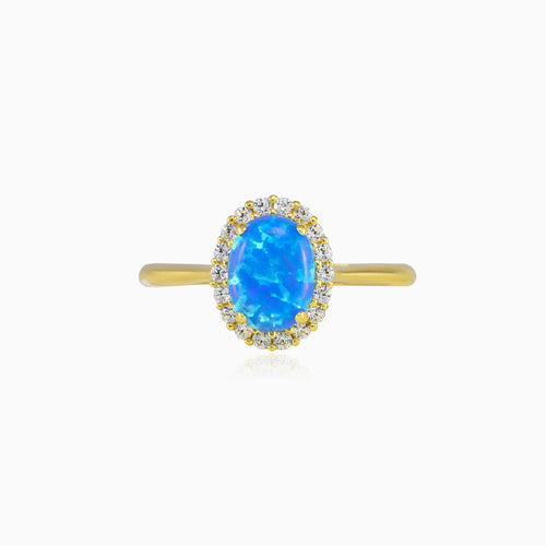 Ovaler Goldring mit blauem Opal und Halo