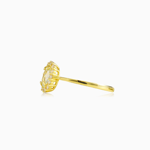 Oval topaz halo gold ring