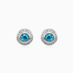 White gold stud earrings with sapphire and diamond halo