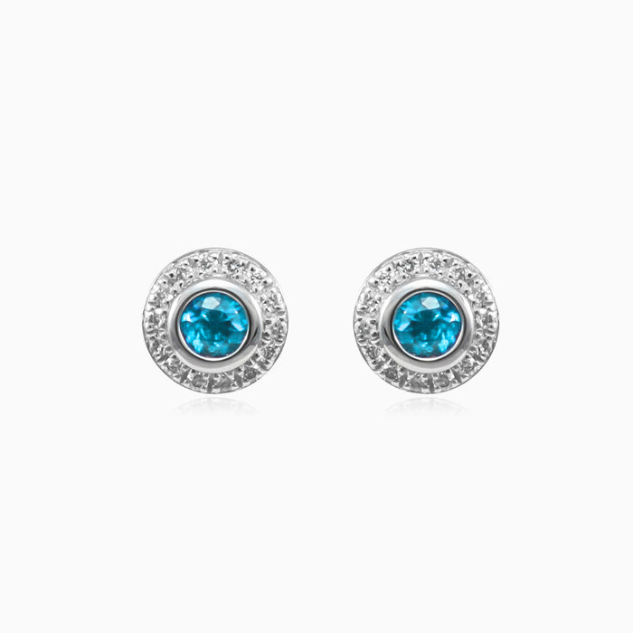 White gold stud earrings with sapphire and diamond halo