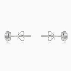 White gold stud earrings with sapphire and diamond halo