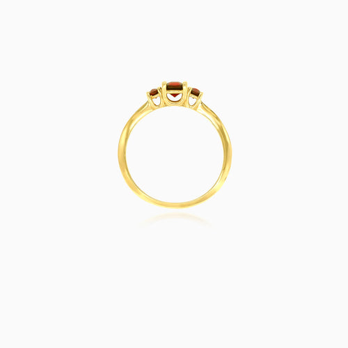 Stylish yellow gold ring with three garnets