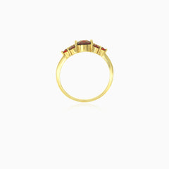 Yellow gold ring with round cut garnets