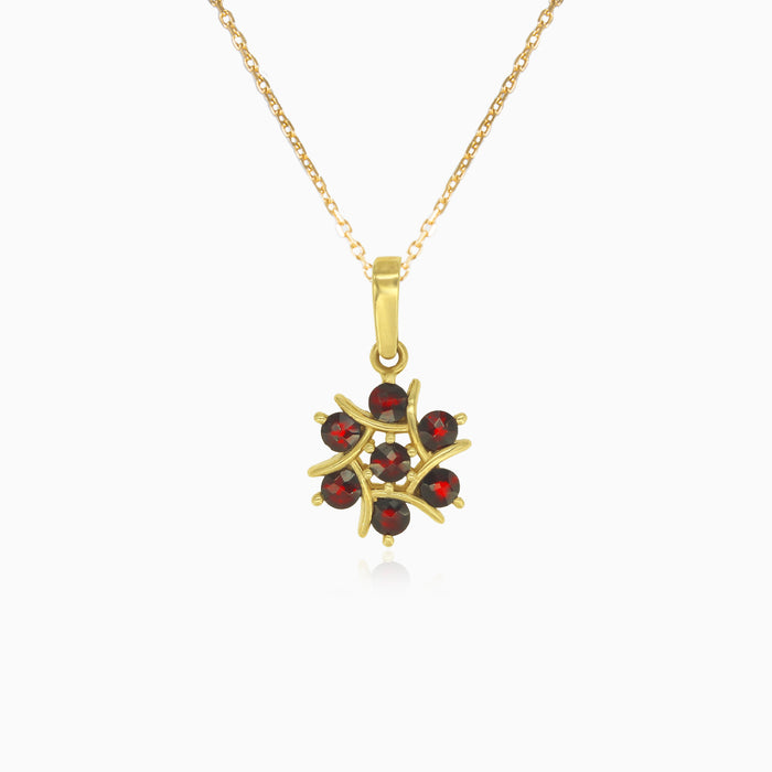 Péndulo de oro con granate floral.