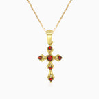 Gold cross pendant with round garnets