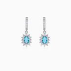 Halo silver dangling earrings with blue topaz