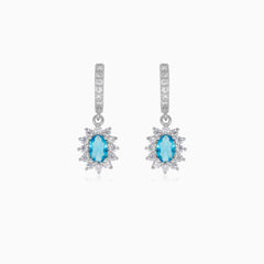 Halo silver dangling earrings with blue topaz