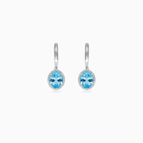 Halo sterling silver dangling earrings with blue topaz