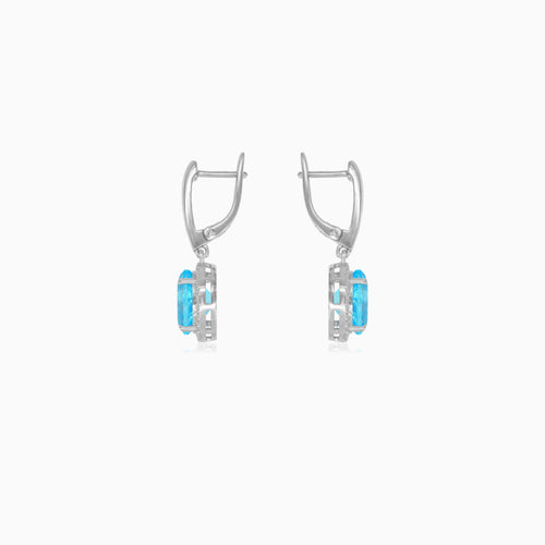 Halo sterling silver dangling earrings with blue topaz