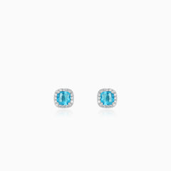 Sterling silver halo stud earrings with blue topaz