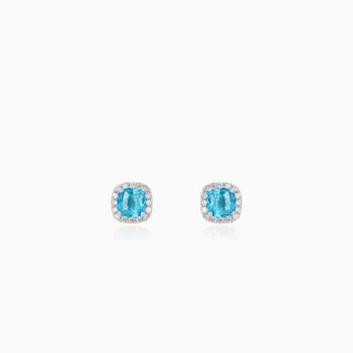 Sterling silver halo stud earrings with blue topaz