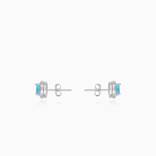 Sterling silver halo stud earrings with blue topaz