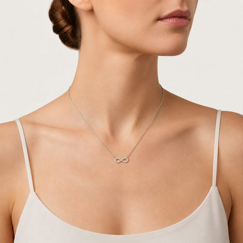 Sterling silver infinity necklace with sparkling round cut cubic zirconia. A refined symbolic design with delicate brilliance for everyday elegance and gifting.