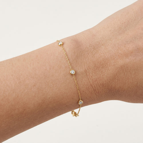 Golden bezel diamond station bracelet