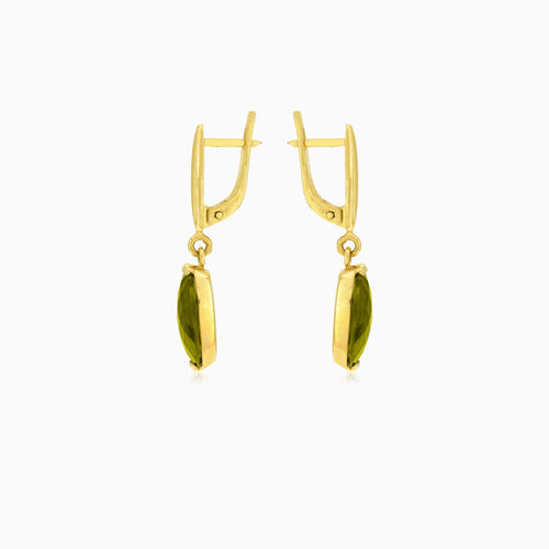 Oval cut modavite in gold earrings