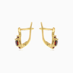 Oval cut garnet earrings with surrounding brilliance