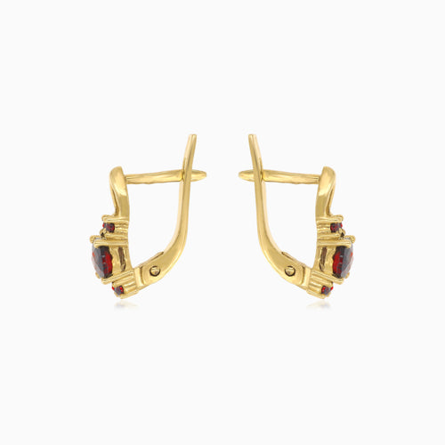 Oval cut garnet earrings with surrounding brilliance