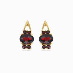 Oval cut garnet earrings with surrounding brilliance