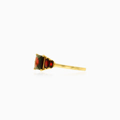 Elegant garnet gold ring with princess and radiant cuts