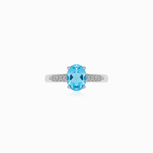 Stříbrný prsten s modrým topazem a kubickými zirkony