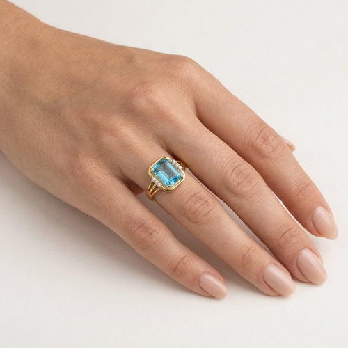 Emerald cut blue topaz diamonds ring in yellow gold