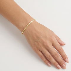 Yellow gold bangle with detailed cuts