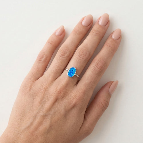 Flat oval blue opal ring