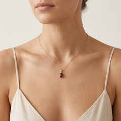 Graceful pear cut garnet pendant in yellow gold