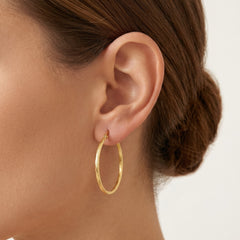 Aros redondos trenzados de oro amarillo