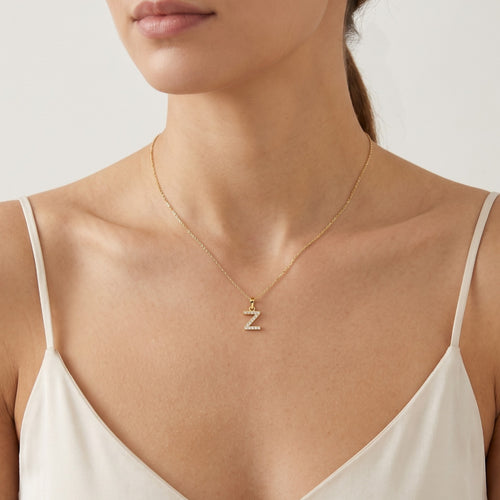 Péndulo de oro con la letra "Z" y circones